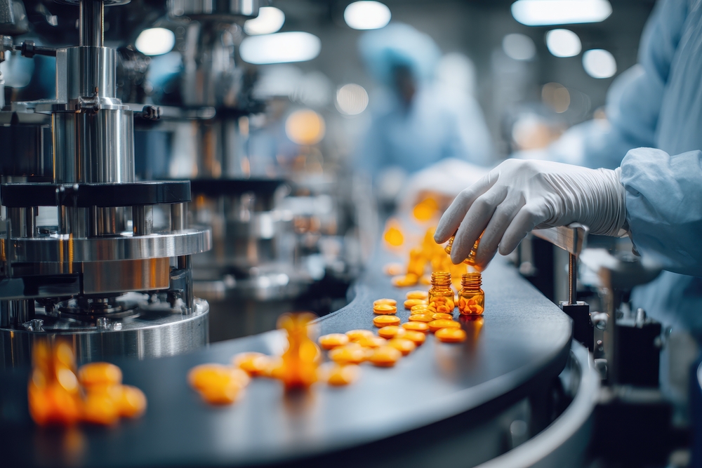 Gloved workers inspecting medication bottles on a pharmaceutical production line, symbolizing accountability in SJS drug lawsuits.